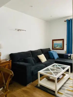 a living room with a black couch and a coffee table at VILLA FALI in Benaguacil