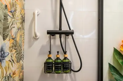 a group of bottles of wine hanging on a wall at Artistic flat next to Ruzafa Welcome to the Jungle in Valencia
