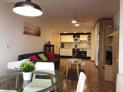 a living room with a couch and a table at Apartamento ARENSOL EN PRIMERA LINEA DE PLAYA in Cullera
