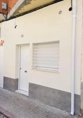 a building with a garage door and a window at UIM Mediterraneo Estudio PB San Jose Wifi in Puerto de Sagunto
