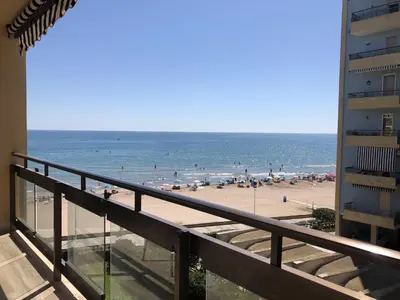 a view of the beach from the balcony of a condo at Modern Apartment Frontline Beach in Mareny Blau