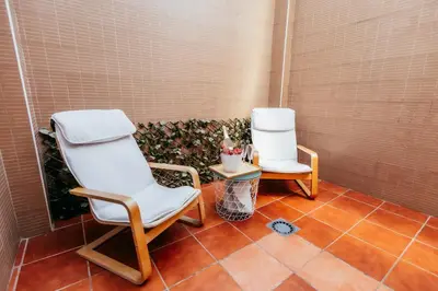 two chairs and a side table on a tile floor at Casa Pancho, ChillOut, Oceanographic, City of Arts in Valencia