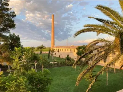 a building with a tall tower in the background at Hotel Rural El Teular in Sueca