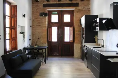 a kitchen with a couch and a table in a room at Las Arenas Suites 1 PLAYA in Valencia