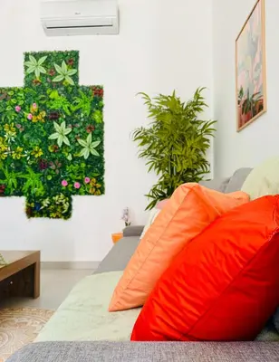 a couch with orange pillows in a living room at Sweet Aparment in Russafa (Soho) in Valencia