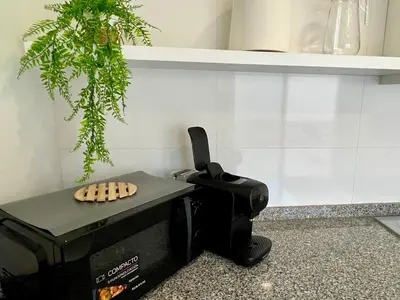a kitchen with a hair dryer sitting on a table at Bonita Planta baja con patio en 1ª línea de playa in Puerto de Sagunto