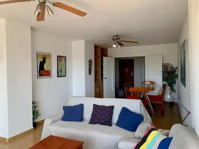 a living room with a couch and a ceiling fan at Big Gran Khan Apartment Canet den Berenguer con Piscina in Canet de Berenguer