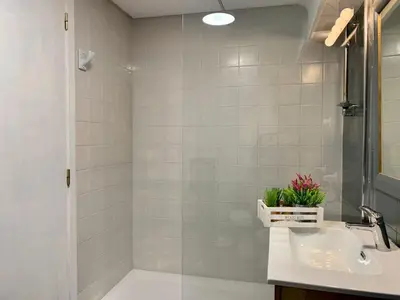 a bathroom with a sink and a shower at Big Gran Khan Apartment Canet den Berenguer con Piscina in Canet de Berenguer