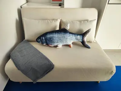 a fish toy sitting on top of a bed at CariSan2 - fully equipped, 6 min to beach in Valencia