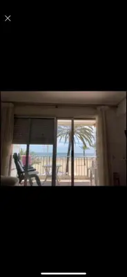 a room with a window with a view of the beach at Frente al mar in Cullera