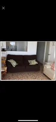 a living room with a couch and a table at Frente al mar in Cullera