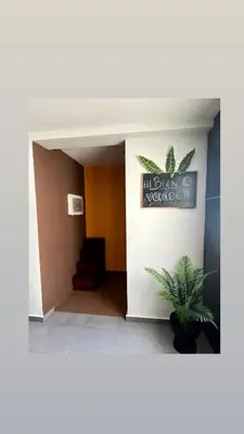 a lobby with a sign on the wall and a plant at Calm Jungle Apartment Near Valencia in Aldaia