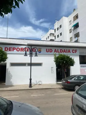 a white building with a sign on the side of it at Calm Jungle Apartment Near Valencia in Aldaia
