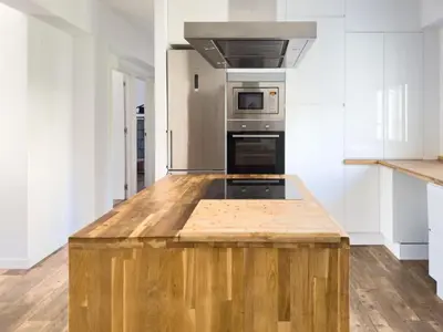 a kitchen with a wooden island with a stove top oven at Apartamento Los Narcisos 2 in Chulilla