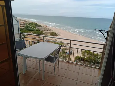 a balcony with a table and a view of the beach at HAWAI, Esc-2, 3-10 in Cullera