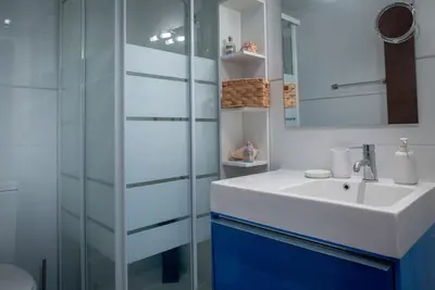 a bathroom with a sink and a glass shower at Patacona Sunrises Premium in Valencia