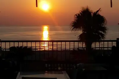 a sunset from the balcony of a condo at Patacona Sunrises Premium in Valencia