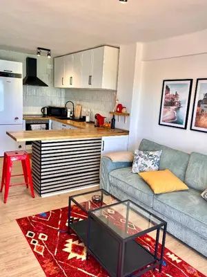 a living room with a couch and a kitchen at El Bikini Cullera - Junto a la playa - Right on the beach in Cullera