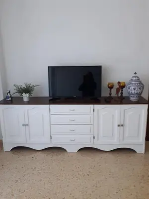 a white entertainment center with a flat screen tv on top at Apartamento Cullera a 200 metros playa San Antonio con parking in Cullera