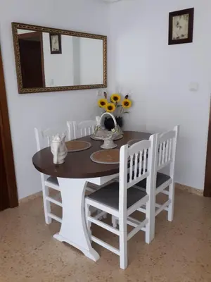 a dining room table with white chairs and a mirror at Apartamento Cullera a 200 metros playa San Antonio con parking in Cullera