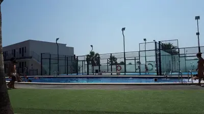 a swimming pool in front of a building at Neo Mediterráneo in Barrio-Mar