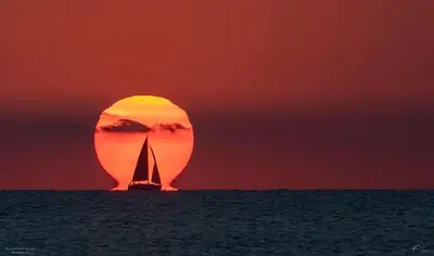 a sail boat in the ocean at sunset at Ubicación ideal in Cullera