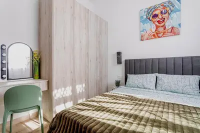 a bedroom with a bed and a chair and a tv at Casa Maravillosa in Valencia
