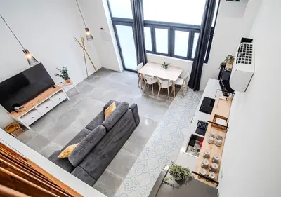 a living room with a couch and a table at AROMA DE VALENCIA II cozy studio with loft in Valencia
