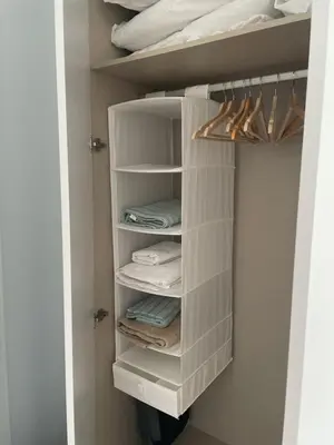 a closet with white shelves and folded towels at Apartment Gran Canet by GRENT in Canet de Berenguer