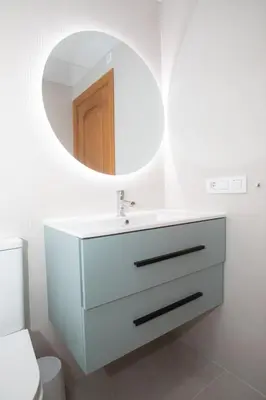 a bathroom with a white sink and a mirror at Gran Chalet con Piscina (8-10 pp) in La Eliana