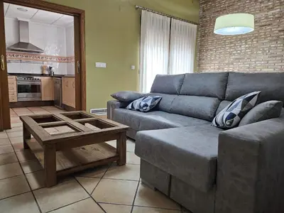 a living room with a couch and a coffee table at Ca Vicent in Estivella