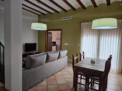 a living room with a couch and a table at Ca Vicent in Estivella