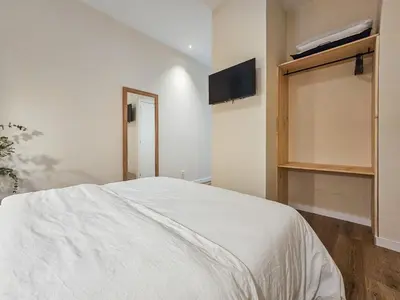 a bedroom with a bed and a tv on the wall at Pivote Flats - Marina A in Valencia