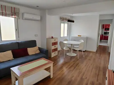 a living room with a couch and a table at Piso cerca universidades y playa in Valencia