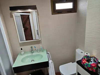 a bathroom with a sink and a mirror and a toilet at Piso cerca universidades y playa in Valencia