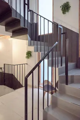 a staircase with black railings in a house at Apartamento elegante en Plaza del Carmen F2 in Valencia