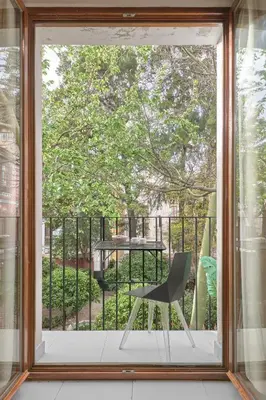 a window with a chair sitting on a balcony at Apartamento de diseño en Plaza del Carmen F4 in Valencia