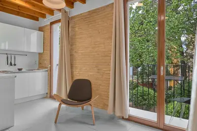 a kitchen with a chair in front of a large window at Apartamento de diseño en Plaza del Carmen F4 in Valencia