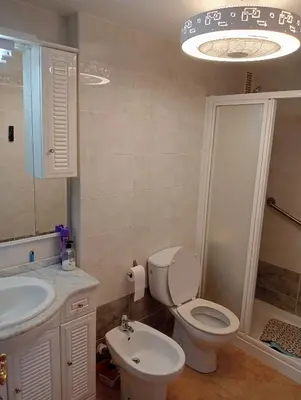 a bathroom with a toilet and a sink and a shower at CANETSOL in Canet de Berenguer