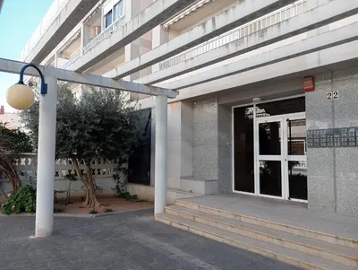 a building with a glass door and a street light at CANETSOL in Canet de Berenguer