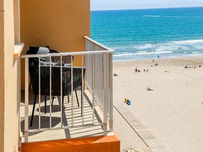 a balcony with a view of a beach and the ocean at El Séptimo Cielo de la Bahía de los Naranjos - Primera Línea de Playa in Cullera