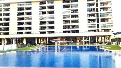 a large building with a swimming pool in front of a building at BEACH VALENCIA LUXURY D9-29 Apartment with terrace and sea views with two rooms in Valencia
