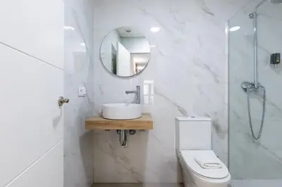 a bathroom with a toilet and a sink and a mirror at VLC HOST - San Jacinto in Valencia