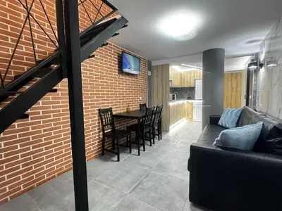 a living room with a couch and a brick wall at Oriola 35 in Valencia