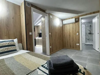 a bedroom with a large bed and wooden walls at Oriola 35 in Valencia