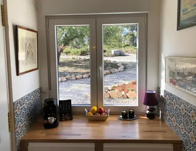 a table with a bowl of fruit in front of a window at Casa the Dutchman in Navarrés