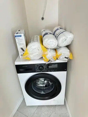 a washing machine with food and containers on top of it at Calma Lofts in Valencia