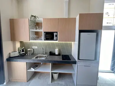 a small kitchen with a sink and a refrigerator at Calma Lofts in Valencia
