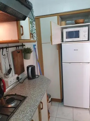 a kitchen with a microwave on top of a refrigerator at apartamento playa surf cullera in Cullera