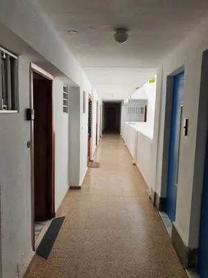 an empty hallway of a building with white walls and blue doors at apartamento playa surf cullera in Cullera